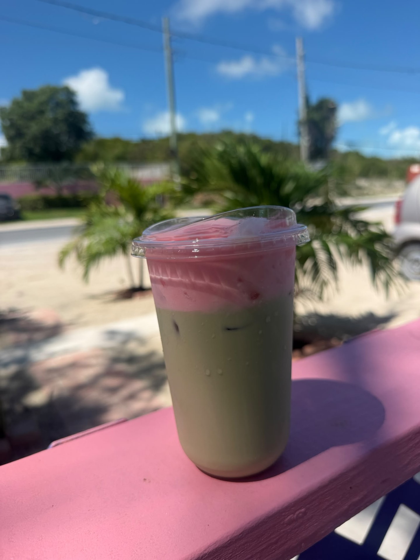 Iced matcha latte with pink cold foam
